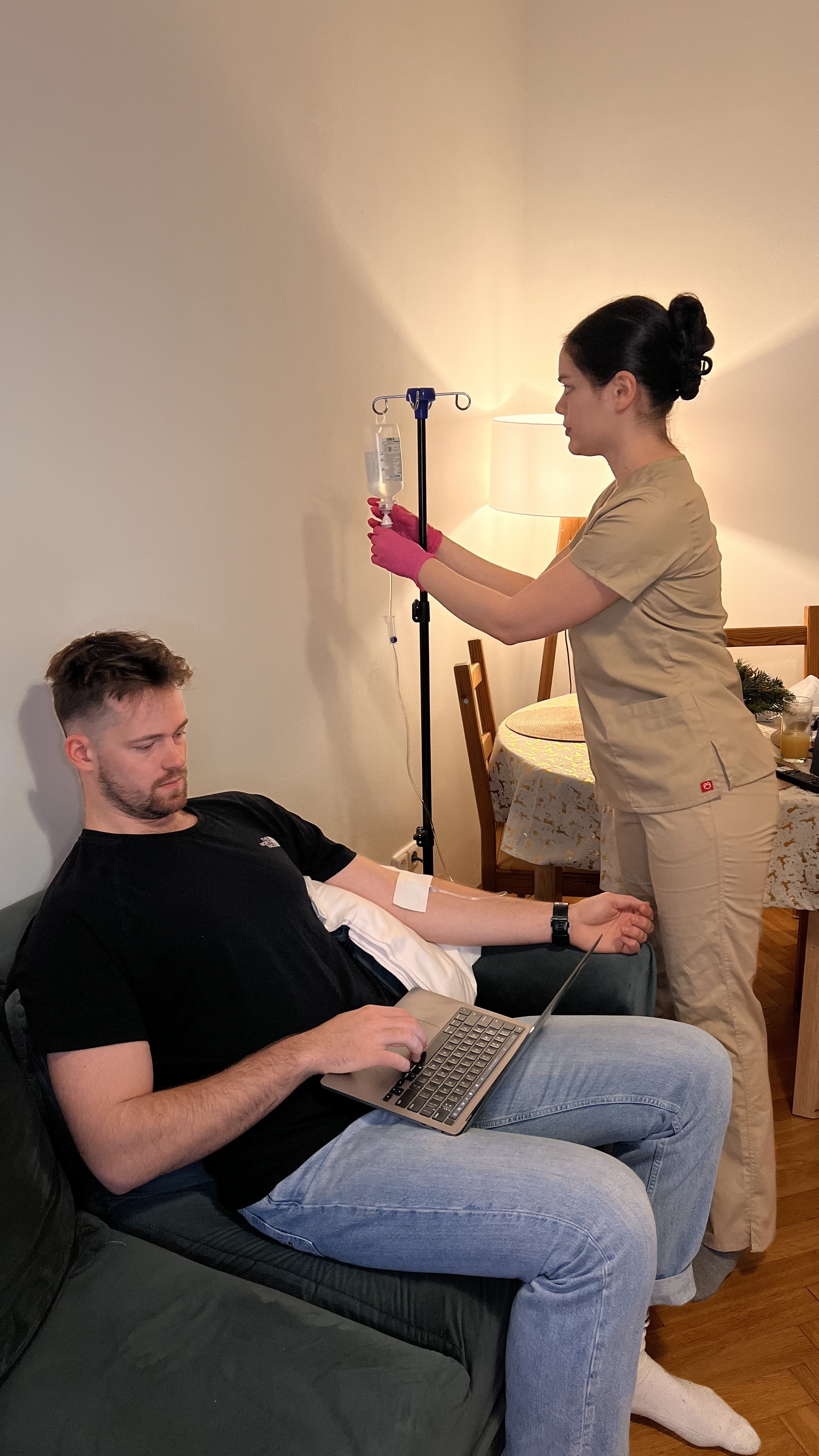 Nurse providing IV therapy in luxury hotel setting
